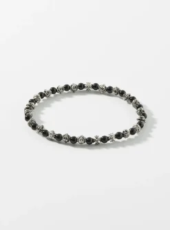 Black bead and grooved cross bracelet