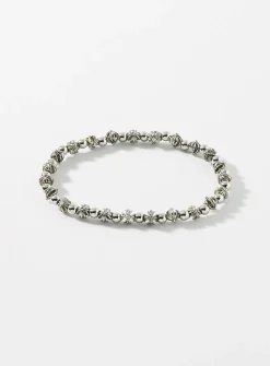 Black bead and grooved cross bracelet