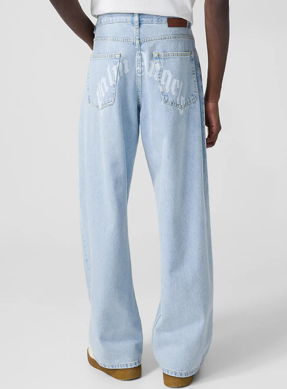 Light blue wide-leg jeans with curved logo